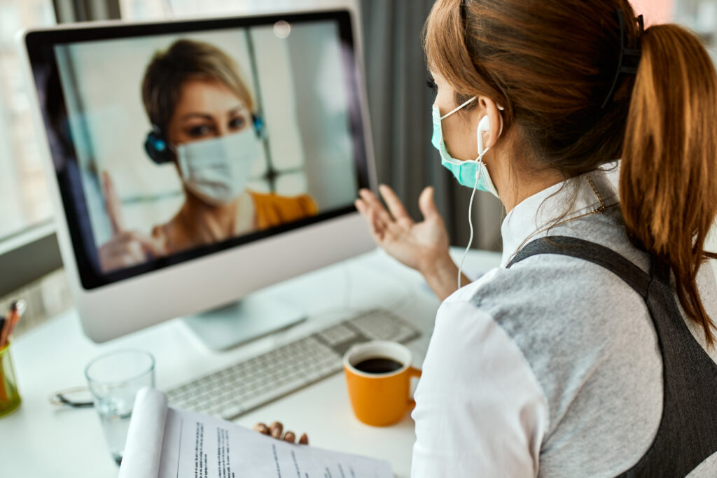 businesswoman with face mask communicating with her colleague via video call while working office covid19 pandemic 1024x683