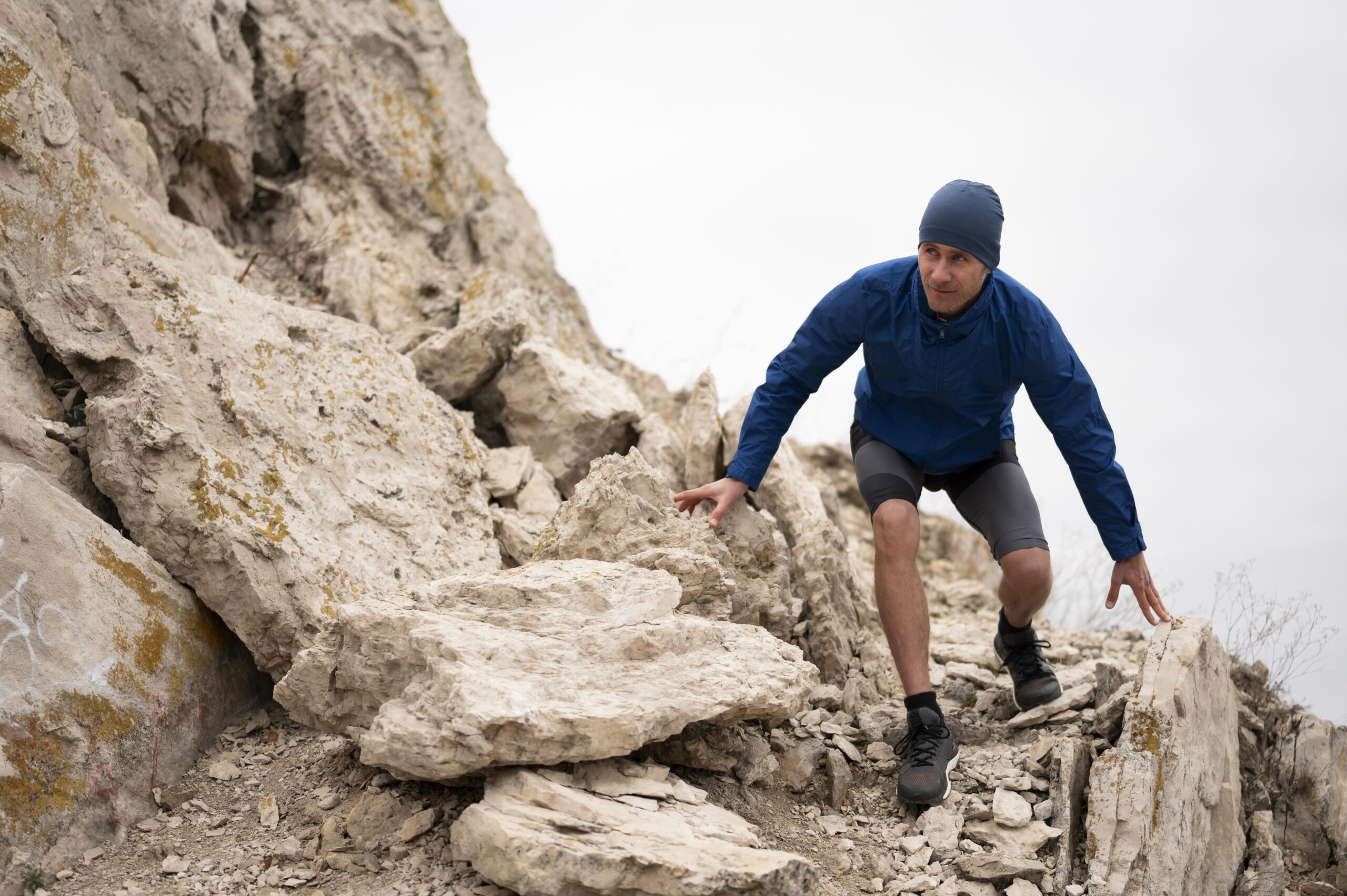 young man walking through rocks nature (3)