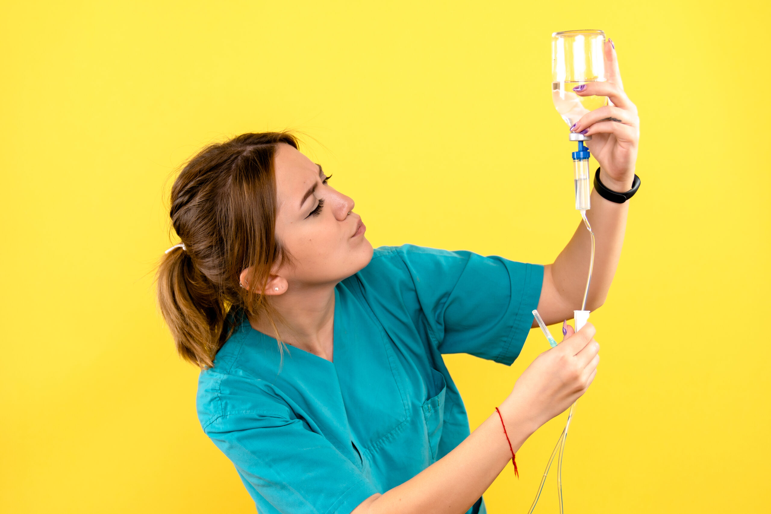 front view female veterinarian holding dropper on yellow desk pe